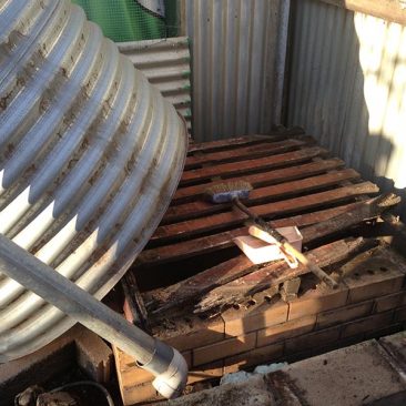 Removing old rotting base and tank ready to replace