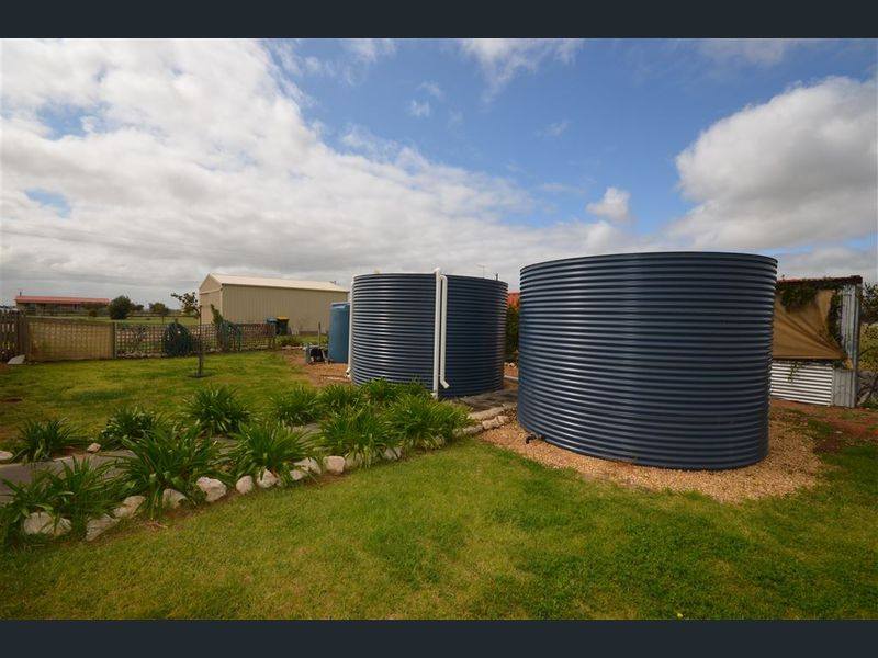 2 rainwater tanks deep ocean colour side by side in rural setting